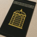 Black Islamic prayer mat made with soft velvet fabric for daily Salah