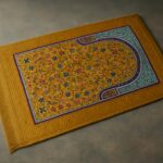 "Yellow prayer mat with intricate geometric patterns, neatly laid on the floor, symbolizing a serene space for worship."