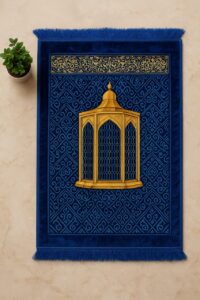 Luxurious royal blue Islamic prayer mat with a golden dome mihrab design and intricate geometric patterns, placed on a marble floor with a potted plant.
